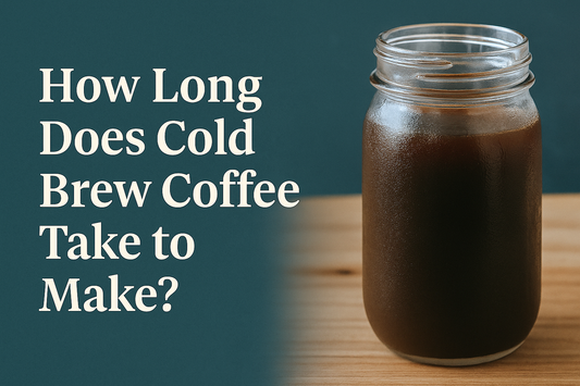 A clear glass jar filled with dark cold brew coffee sits on a wooden surface, with condensation on the outside and a soft focus background, representing a freshly made batch of homemade cold brew.