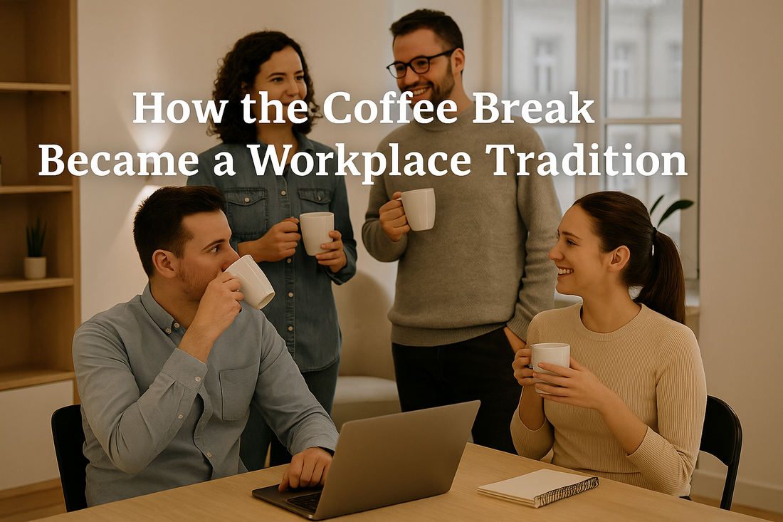 Four coworkers enjoying a coffee break in a modern office, smiling and talking while holding mugs, with sunlight streaming through large windows