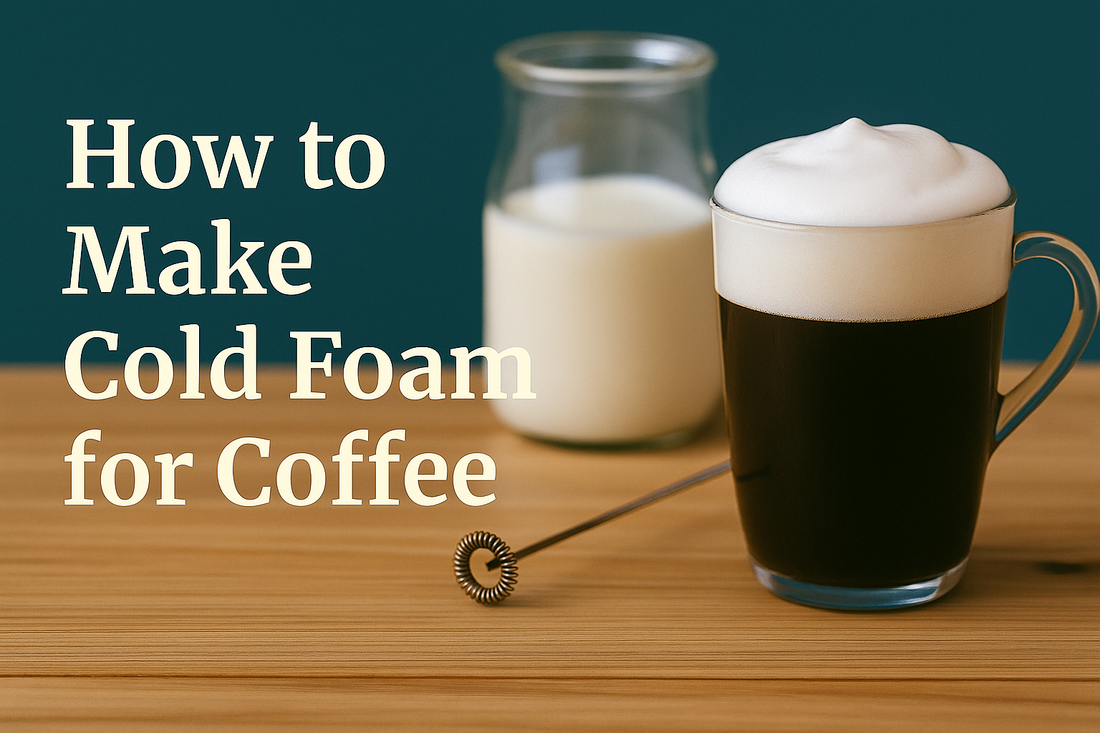 A glass of iced coffee topped with cold foam, placed beside a jar of milk and a milk frother on a wooden table, with the text 'How to Make Cold Foam for Coffee' displayed on a teal background