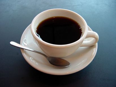 Coffee cup on a saucer with a spoon