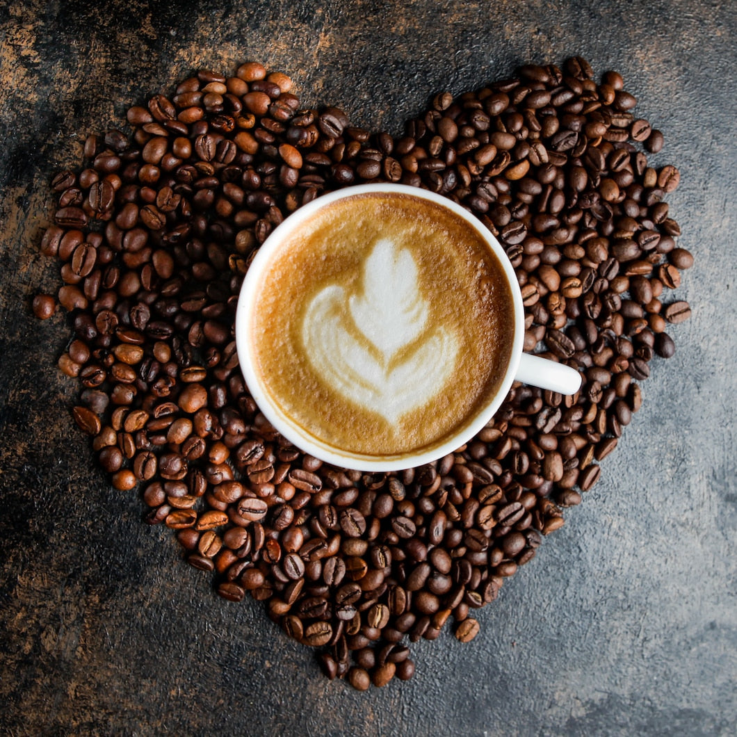 Coffee surrounded by coffee beans