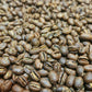 lose-up of roasted Tanzania Peaberry coffee beans from Five Star Coffee, featuring small, round single-origin beans with a bright, fruity flavor profile.